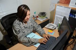 Servicewoman typing at computer